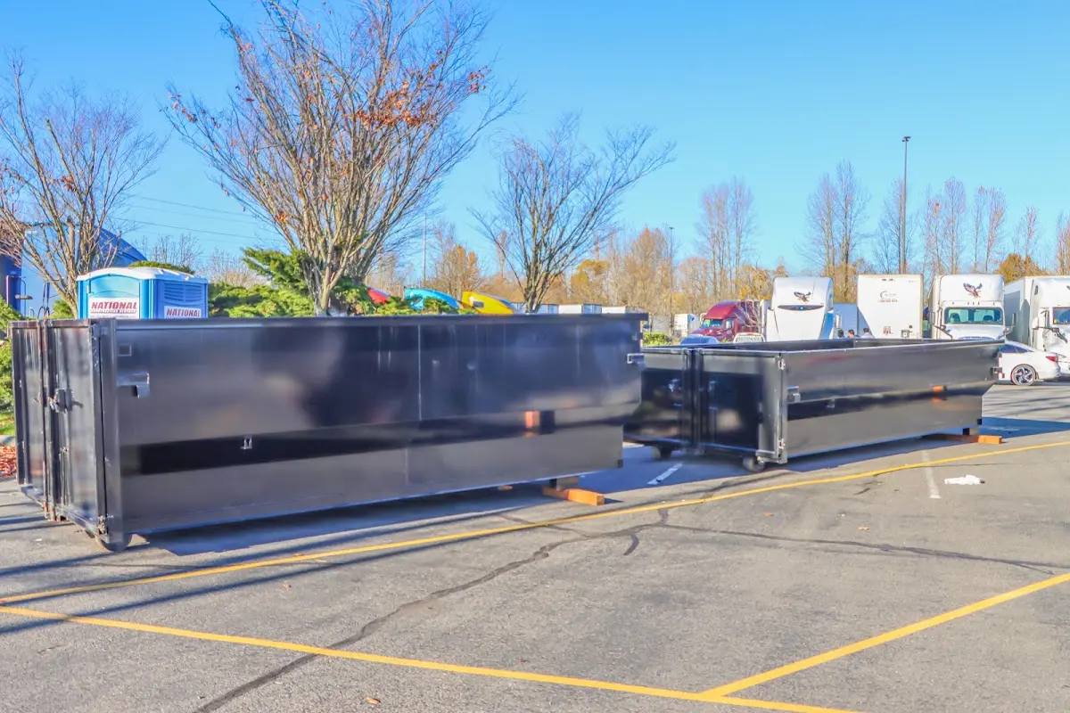 Professional dumpster rental service with roll-off container on residential driveway in Lake Ridge